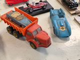 many toy cars on a table with other toy cars