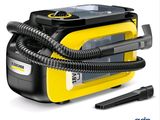 the yellow and black steam cleaner is sitting next to a black and white device