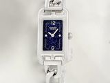 a silver watch with a blue face on a chain bracelet