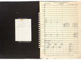 an open notebook with music notes and a notepad on it
