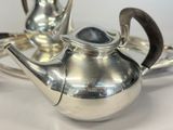 a silver tea pot sitting on a silver tray