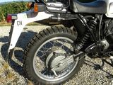 a motorcycle that is parked on a gravel road