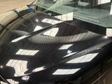 a reflection of a person on the windshield of a car