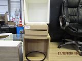a desk with a chair and a computer on it in a store