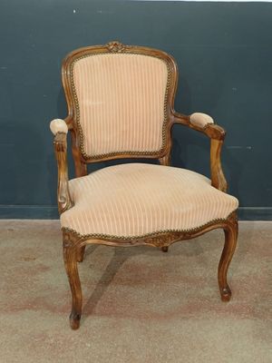 an antique chair with a beige upholstered seat and a beige upholstered seat