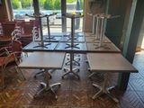 tables and chairs in a large room with a lot of windows