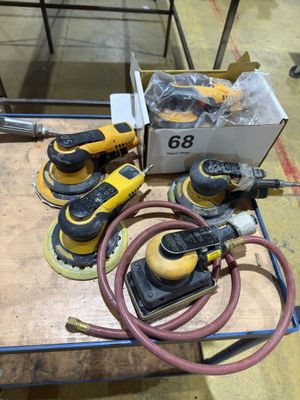 a group of power tools sitting on top of a wooden table