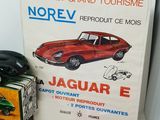 a red toy car and a box of toys on a table