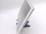 a tablet computer sitting on a stand on a table