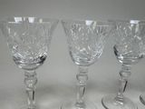 three wine glasses sitting next to each other on a table