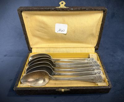 four spoons and a spoon in a case