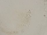 an image of a close up of a white plate with a bird on it