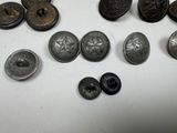 several different types of metal buttons and buttons on a white surface