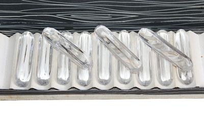 six silver spoons in a silver case on a white surface