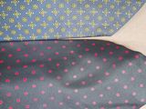four different colored neck ties are lined up on a table
