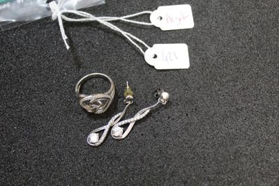 two rings and a pair of earrings on a table