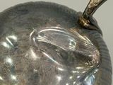 a metal object that looks like a fish on a table