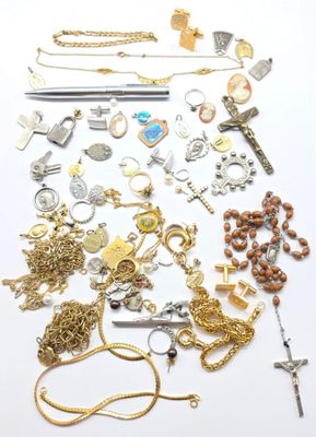 a lot of gold and silver jewelry on a white surface