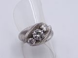 sterling silver ring with clear crystal stones on a clear acrylic ring