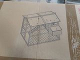 a cardboard box with a drawing of a house on it