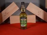 a bottle of olive oil sitting on a red table