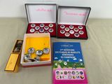 three boxes of silver coins and a book on a table