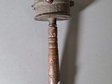 a small metal object with a red bead on it