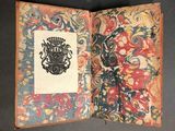 a book with a picture of a coat of arms on it