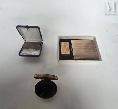 a small box of makeup and a compact case on a table