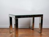 a chrome and glass coffee table on a wooden floor