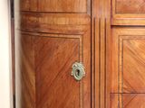 a wooden cabinet with a marble top in a bathroom