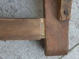 a close up of a wooden bench on a sidewalk