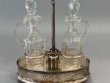 an image of a silver plate with three glass decanters on it