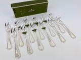 six forks and a box of silverware on a white surface