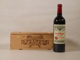 a bottle of wine sitting next to a wooden box