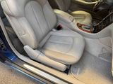 the interior of a car with the door open and the seat up