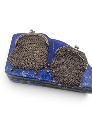 pair of silver and blue stone earrings on a blue tray