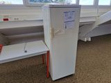 a white refrigerator sitting in the corner of a room