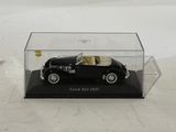 a black model of a car in a clear case