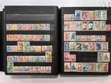 two black folders with stamps on them on a table