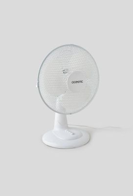 a white fan sitting on top of a white table