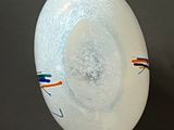 a white plate with a blue and orange stripe on it