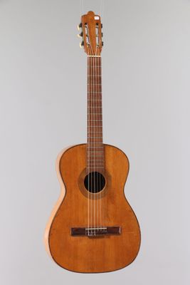 an acoustic guitar hanging from the ceiling in a room