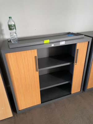 two shelves with bottles of water on them and a bottle of water on top of them