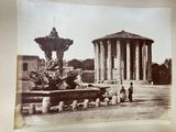 an old photo of a fountain in the middle of a park