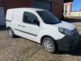 a white van parked in front of a brick building