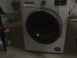 a washing machine sitting in the corner of a room