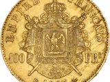 a gold coin with a coat of arms and a crown on it