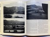 an open book with pictures of mountains and a river in it