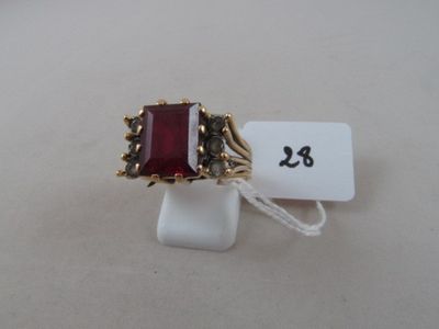 an image of a ring with a red stone in it